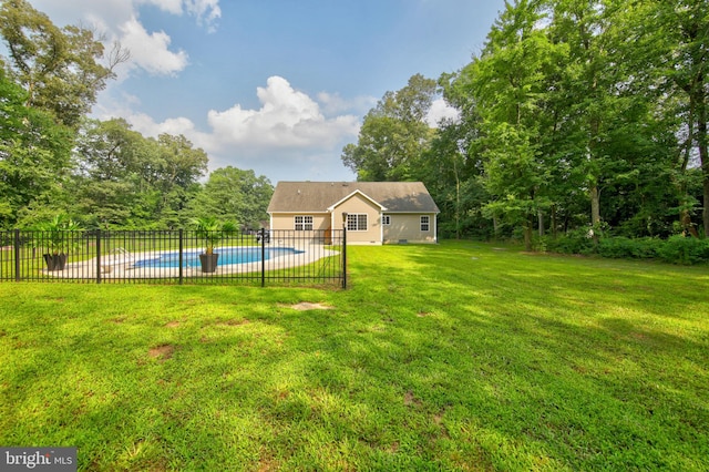 view of yard featuring a fenced in pool and an outdoor structure