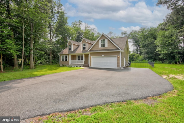 view of front of house featuring a front yard and a garage