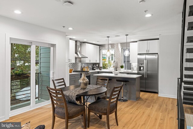 dining space featuring light hardwood / wood-style flooring and sink