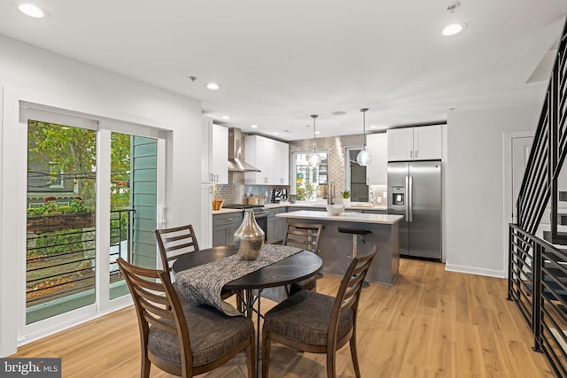 dining space featuring light hardwood / wood-style flooring and a wealth of natural light