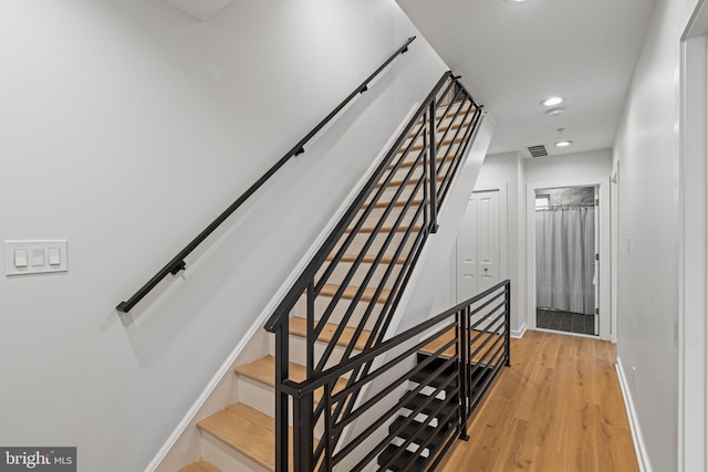 staircase with wood-type flooring