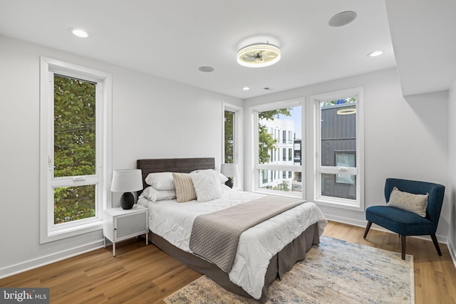 bedroom with hardwood / wood-style flooring