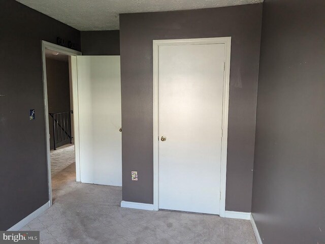 unfurnished bedroom with a textured ceiling