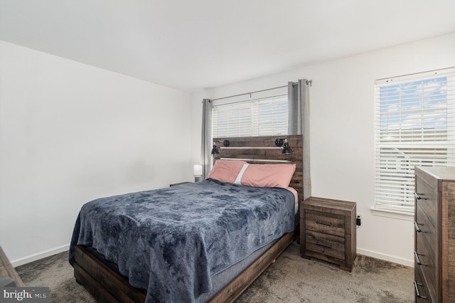 carpeted bedroom featuring multiple windows