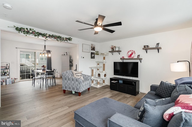 living room with ceiling fan and light hardwood / wood-style flooring