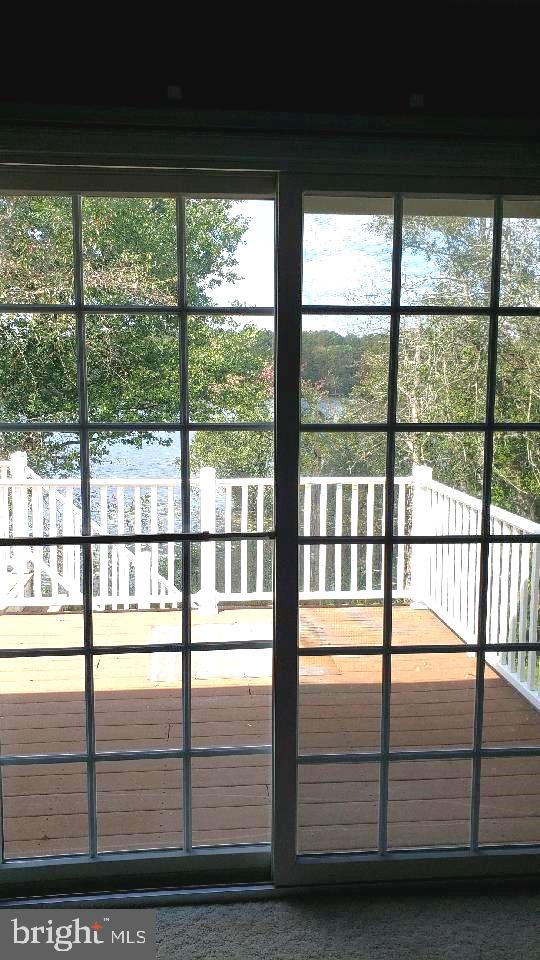 doorway to outside featuring carpet floors