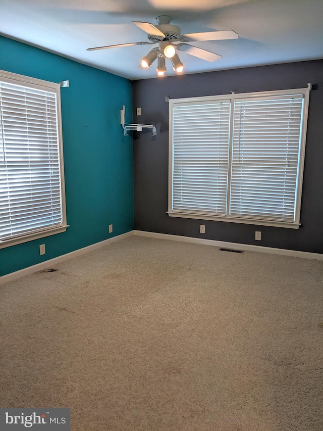 spare room featuring ceiling fan and carpet flooring