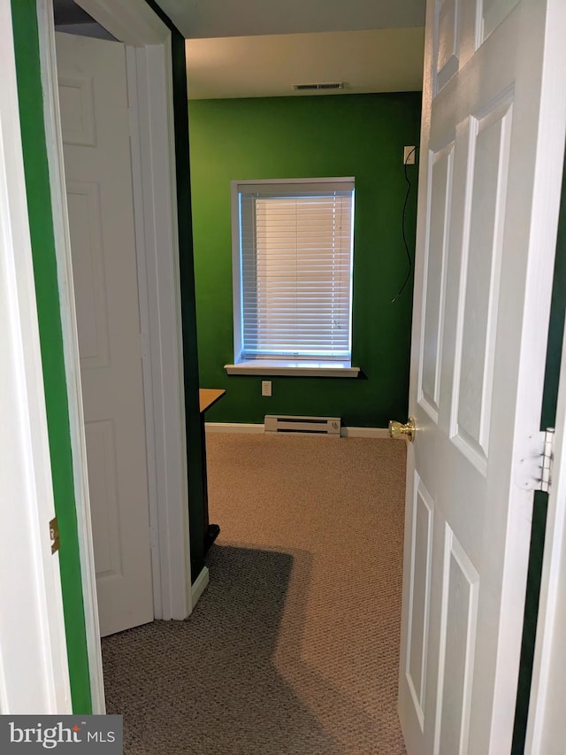 corridor featuring a baseboard radiator and carpet flooring