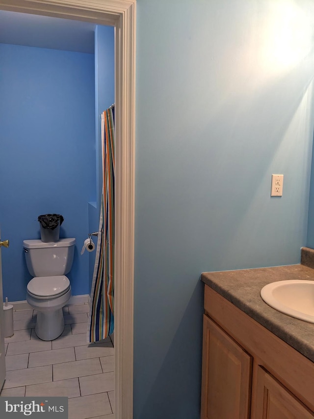 bathroom featuring vanity, toilet, and tile patterned floors