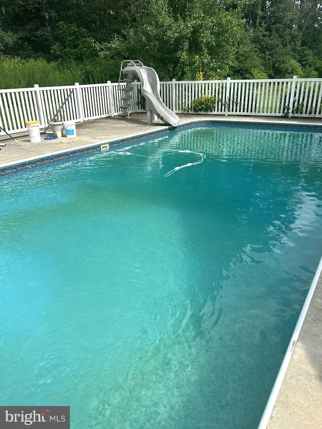 view of pool with a water slide