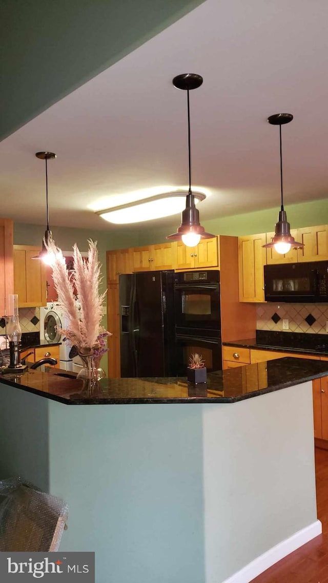 kitchen with light brown cabinetry, black appliances, decorative light fixtures, decorative backsplash, and dark hardwood / wood-style floors