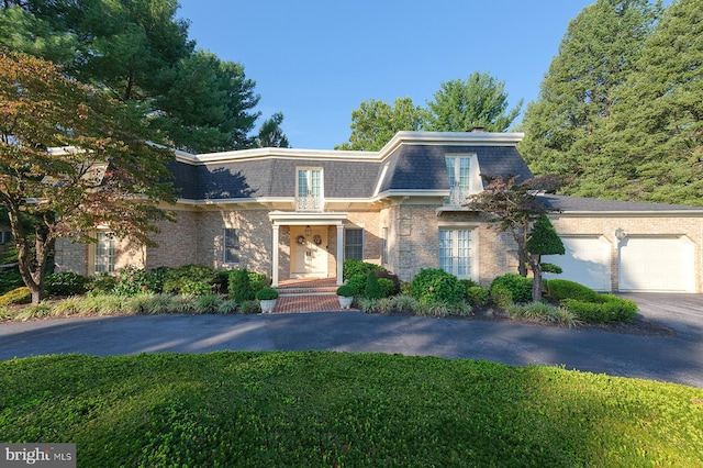 view of front of property with a garage and a front lawn