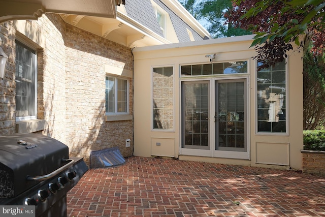 view of exterior entry featuring a patio area