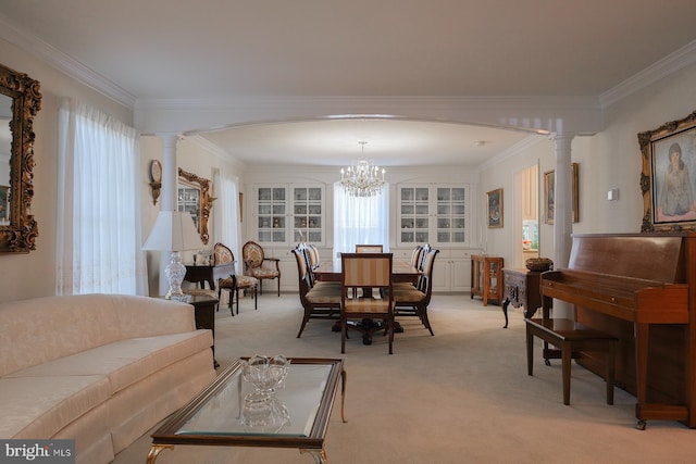 carpeted living room with crown molding, an inviting chandelier, and ornate columns