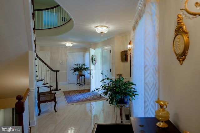 entryway featuring crown molding