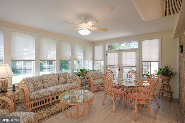 sunroom with ceiling fan and french doors