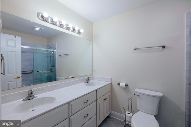 bathroom featuring vanity, toilet, and a shower with shower door