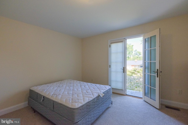 carpeted bedroom with access to outside