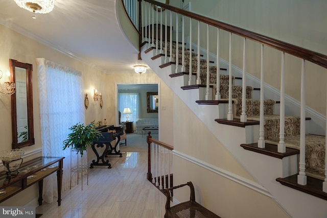 stairway featuring crown molding