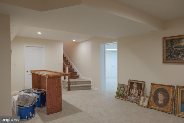 basement featuring light colored carpet