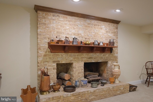 room details with a brick fireplace, carpet floors, and ornamental molding