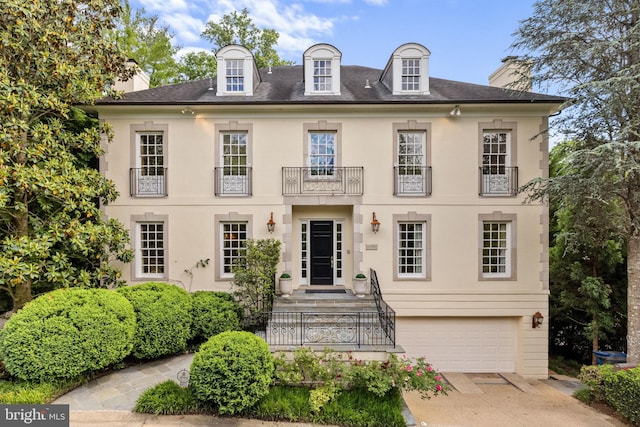 view of front of house featuring a balcony and a garage