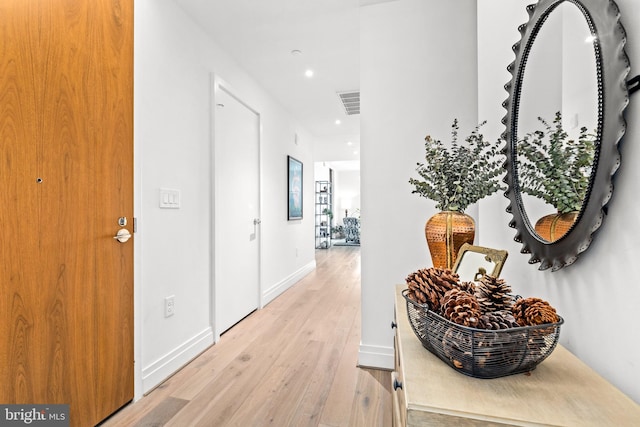 hall with light hardwood / wood-style floors