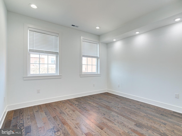 empty room with dark wood-type flooring