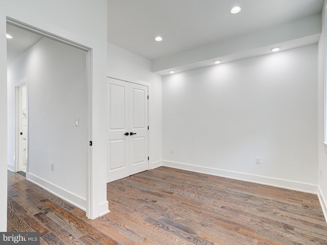 empty room featuring dark wood-type flooring