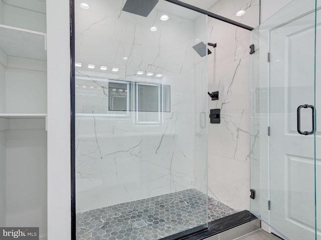 bathroom featuring a shower with door