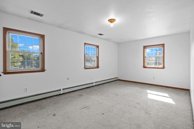 carpeted empty room with a baseboard radiator