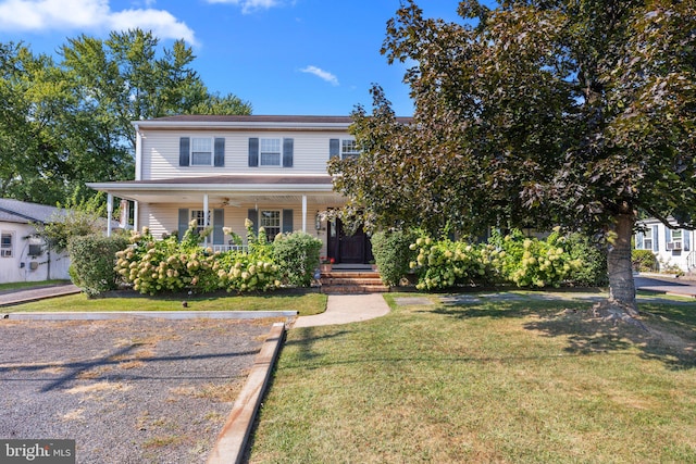 view of front of home featuring a front lawn and covered porch