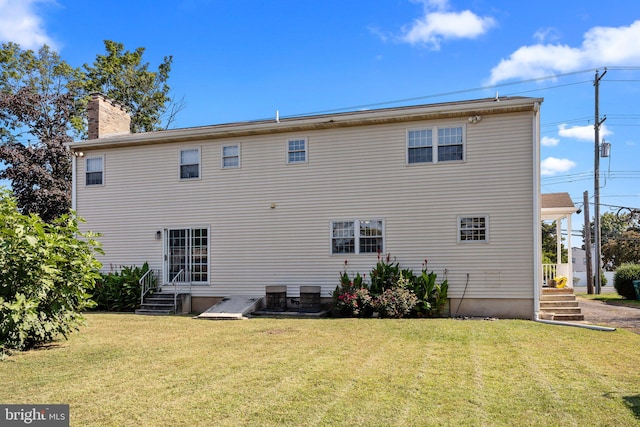 back of house featuring a yard