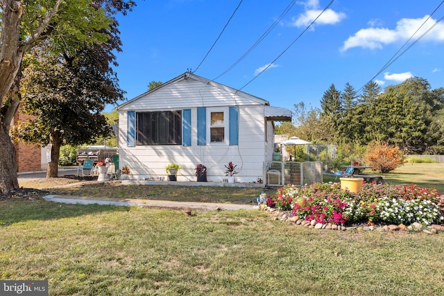 view of side of property with a yard