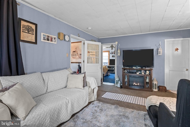 carpeted living room with ornamental molding