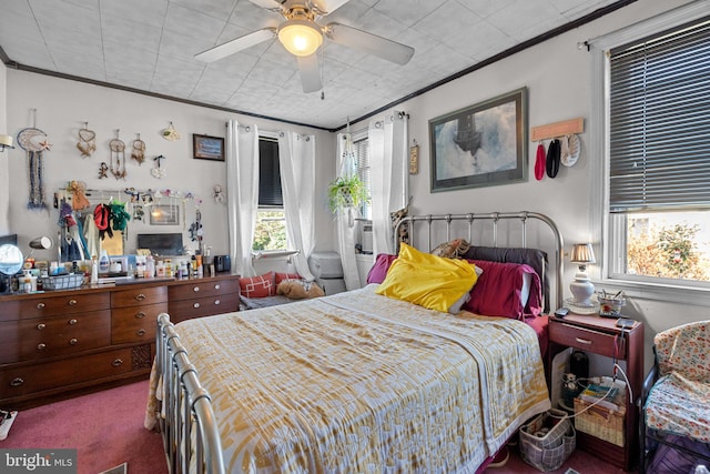 carpeted bedroom with crown molding and ceiling fan