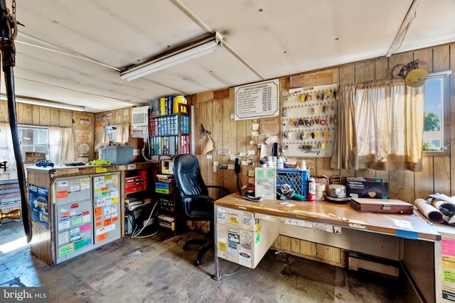 office space with wooden walls, a workshop area, and an AC wall unit