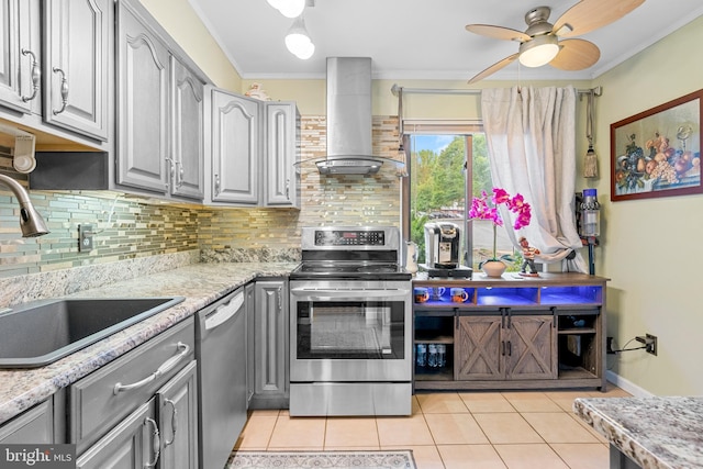 kitchen featuring appliances with stainless steel finishes, gray cabinetry, island exhaust hood, ceiling fan, and ornamental molding