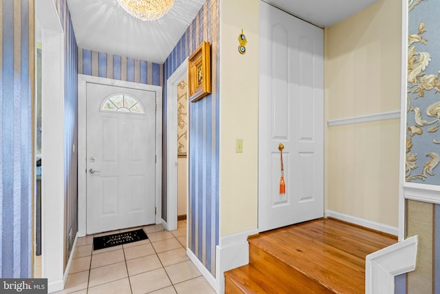 entrance foyer featuring light hardwood / wood-style floors and a notable chandelier