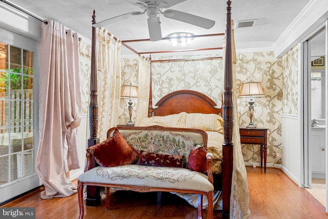 bedroom featuring ornamental molding, light hardwood / wood-style floors, ceiling fan, and multiple windows