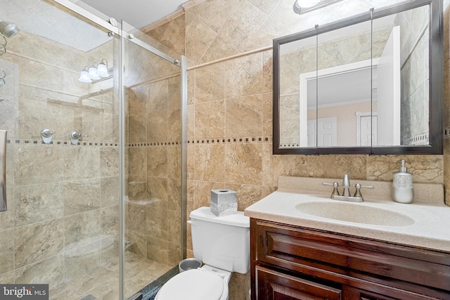 bathroom with vanity, tasteful backsplash, a shower with shower door, tile walls, and toilet