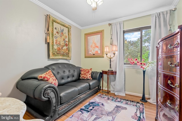 living room featuring ceiling fan, light wood-type flooring, and ornamental molding