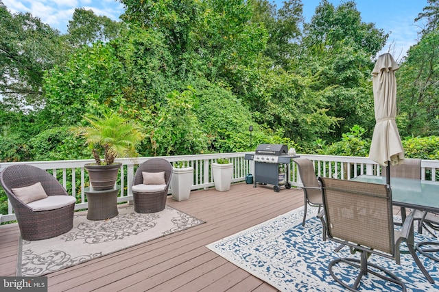 wooden terrace featuring a grill