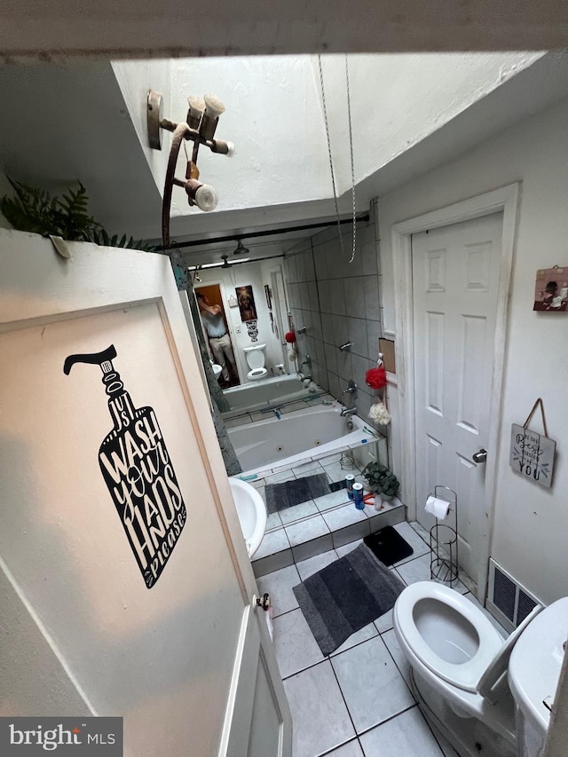 bathroom with  shower combination, tile patterned flooring, and toilet