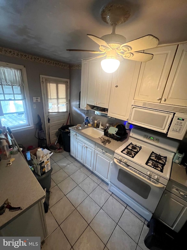 kitchen featuring ceiling fan, white cabinets, sink, and white appliances