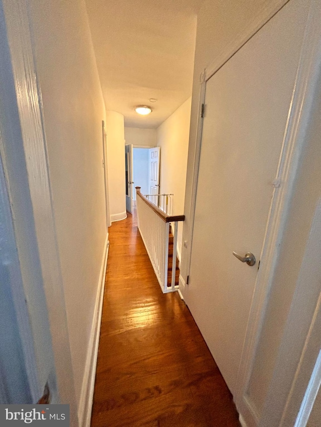 corridor featuring wood-type flooring