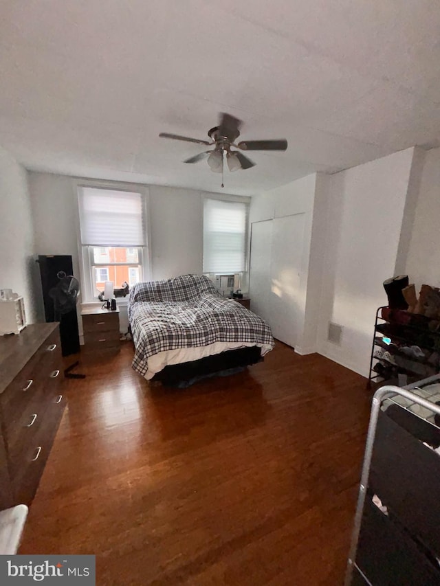 bedroom featuring ceiling fan and dark wood-type flooring