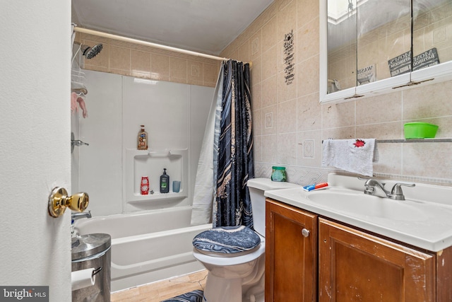 full bathroom featuring vanity, tile walls, toilet, and shower / tub combo with curtain