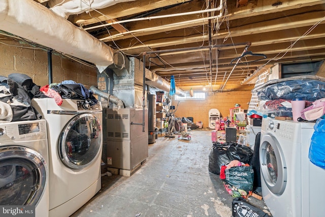 basement with washing machine and clothes dryer and water heater