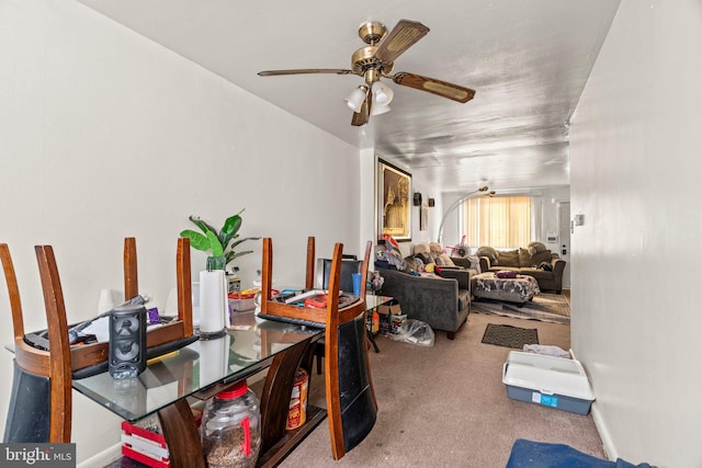 carpeted dining area featuring ceiling fan